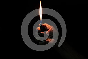 Old Man hand holding burning lighter
