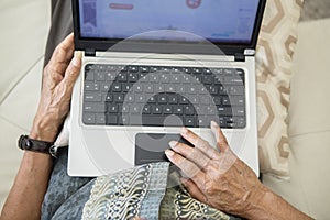 Old man hands typing on the laptop