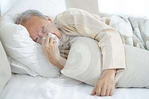 Old man have a covid virus and take quarantine on the bed at his home