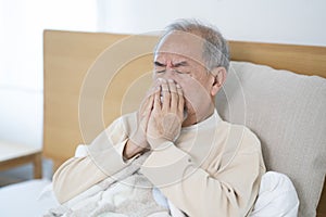 Old man have a covid virus and take quarantine on the bed at his home