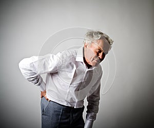 Old man is having a back pain.