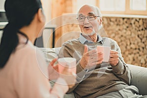 Old man having friendly conversation with his female friend