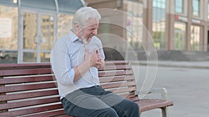 Old Man having Heart Pain while Sitting on Bench Outdoor