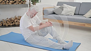 Old Man Having Knee Pain on Excercise Mat at Home