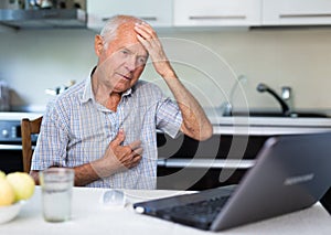 Old man having online medical consultation through internet