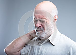 Old man having pain in the neck