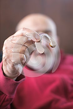 old man with hearing aid