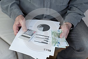 Old man holding bills