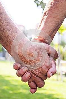 Old man holding child`s hands. selective focus