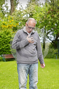 Old man holding his chest