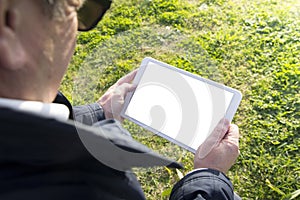 Old man holding tablet with white screen