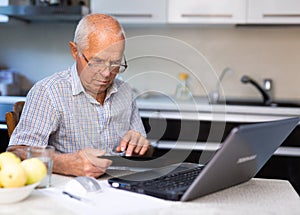 Old man with laptop and tablet