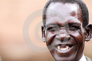 An old man laughing with no teeth