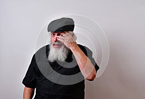 Old man looking between his fingers