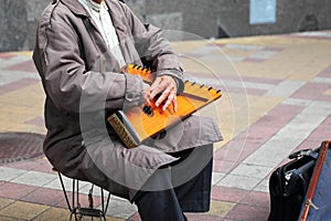 Old man with the musical instrument Gusli