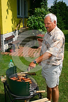 Old man outside cooking