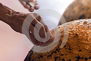 Old man pastes golden leaf on buddha statue