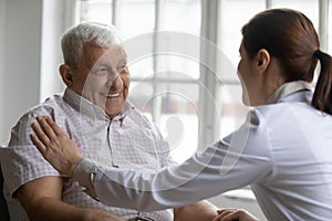 Old man patient and careful nurse communication indoors