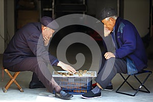 Old man play Chinese Chess