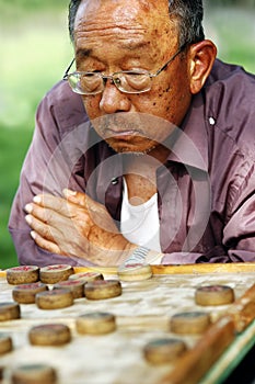 Old man play Chinese Chess