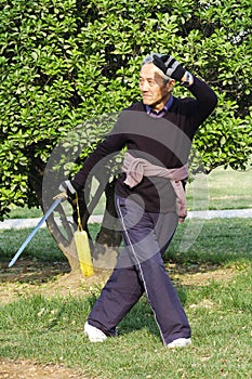 Old man play Taiji sword