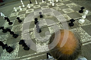Old Man Playing Oversize Chess
