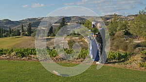 Old man prepares to play golf and taking the golf club from the bag