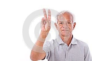 Old man raising 2 fingers, victory gesture