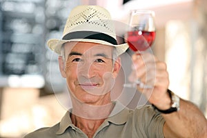 Old man raising a glass