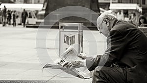 The old man read the newspaper