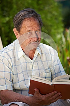 Old man reading book