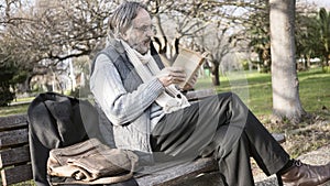 Old man reading book in the park