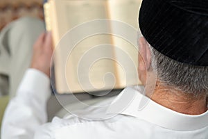 An old man reading the book. Selective focus