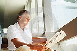 Old man, reading and newspaper in home or article for global current events, stock market or journalism. Male person