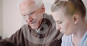 Old Man Retirement - Smiling senior man talking with granddaughter