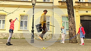 Old man rope skipping with three girls.