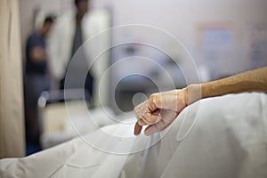 Old Man's Hand on Hospital Bed