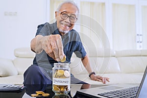 Old man savings coins in jar with retirement text