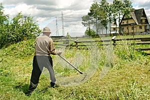 Old man with scythe photo