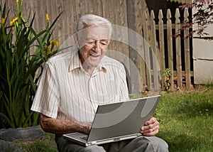 Old man senior working on computer