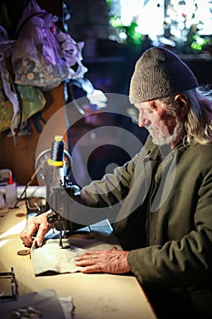 Old man sewing