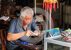 The old man sewing in zhaoxin,guizhou,china