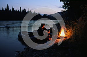 The Old Man Sits On The River Bank By The Fire