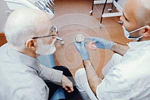 Old man sitting in the dentist`s office