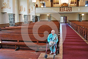Elderly man sitting in an empty church photo