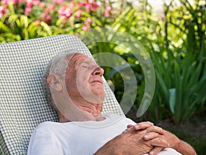 Old man sleeping in garden
