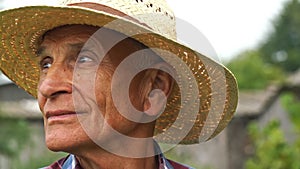 Old man with smile on face looks around garden slow motion