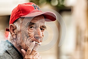 Old man smoking a cigarette on the bench in Zagreb center square