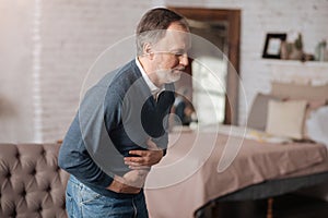 Old man with strong stomach-ache