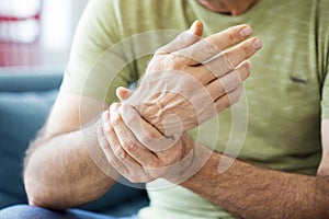 Old man suffering from pain and rheumatism photo